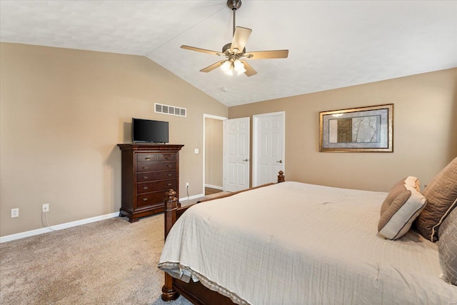 carpeted bedroom featuring a ceiling fan, lofted ceiling, visible vents, and baseboards