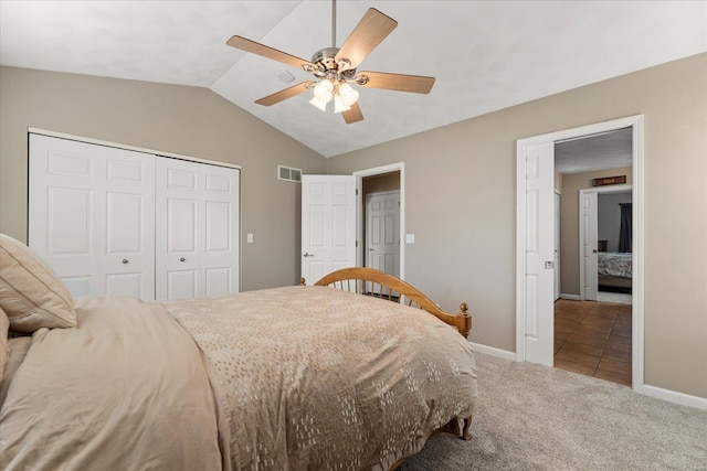 carpeted bedroom with baseboards, visible vents, a ceiling fan, vaulted ceiling, and a closet