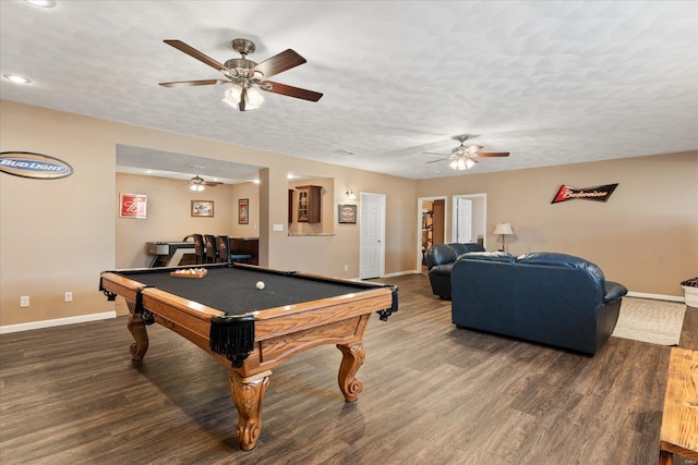 playroom with a textured ceiling, baseboards, and wood finished floors