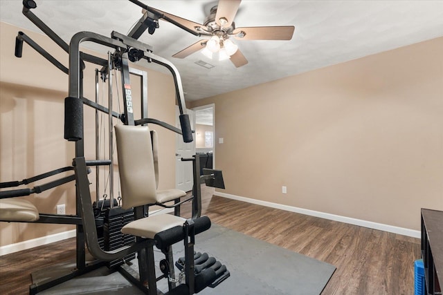 exercise room with ceiling fan, wood finished floors, visible vents, and baseboards