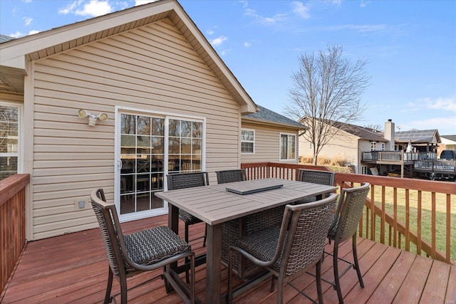 wooden terrace featuring outdoor dining area