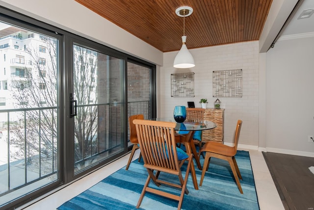 dining space with wooden ceiling, a wealth of natural light, and baseboards