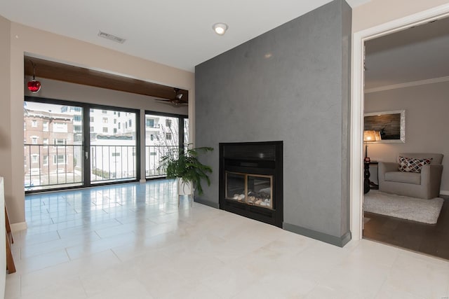 living room featuring ceiling fan, a glass covered fireplace, visible vents, and crown molding