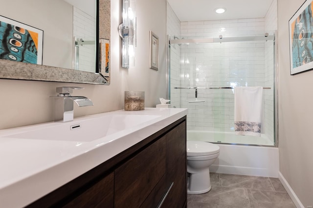 full bathroom with toilet, enclosed tub / shower combo, vanity, baseboards, and tile patterned floors