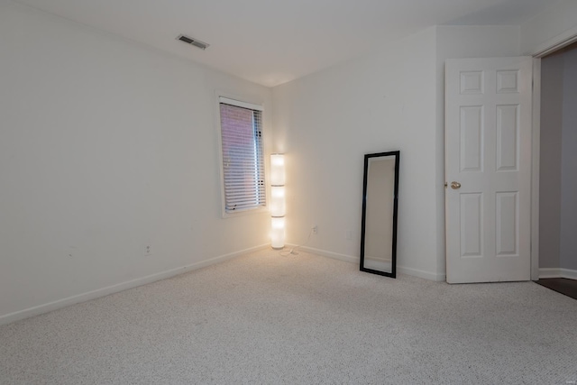 unfurnished room featuring carpet, baseboards, and visible vents