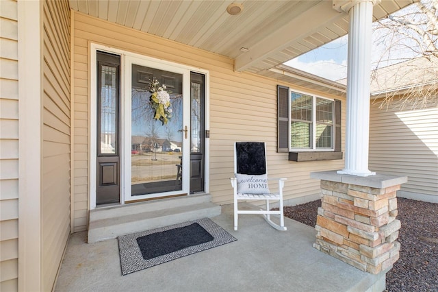 view of exterior entry featuring a porch