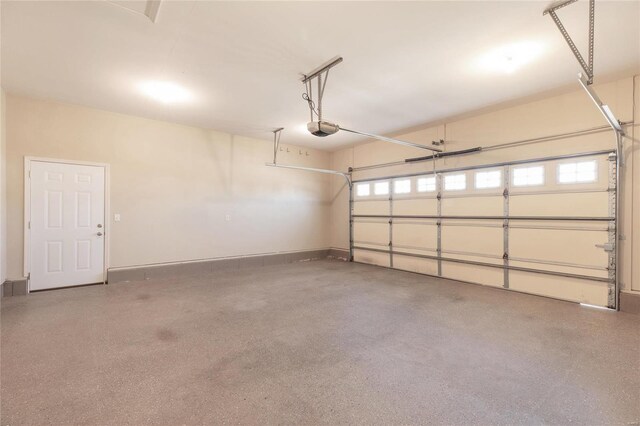 garage with baseboards and a garage door opener