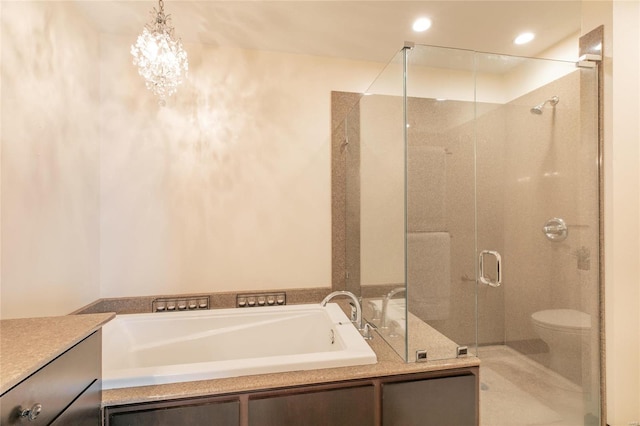 full bathroom featuring a stall shower, toilet, vanity, a bath, and recessed lighting