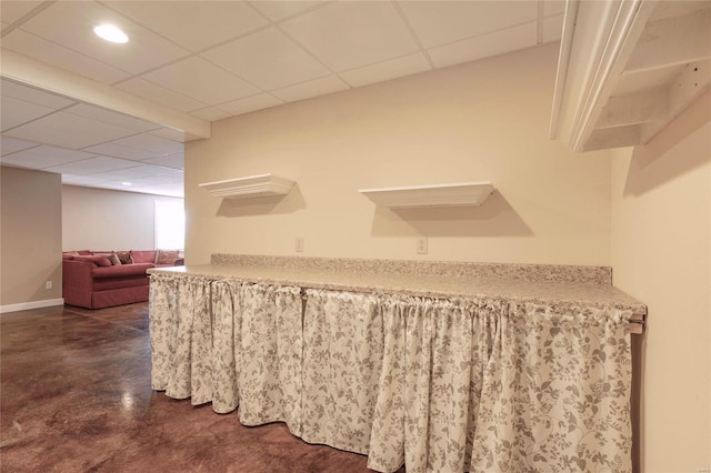 bar with recessed lighting, concrete floors, a drop ceiling, and baseboards