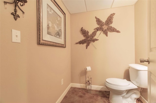 bathroom with toilet and baseboards