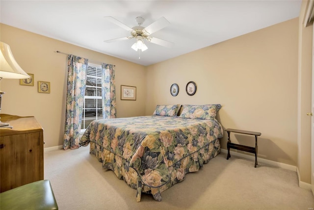 carpeted bedroom featuring a ceiling fan and baseboards