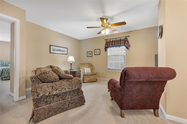 sitting room with a ceiling fan, carpet flooring, and baseboards