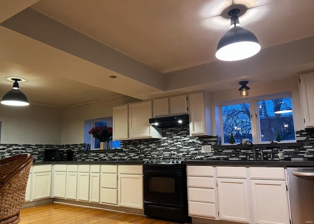 kitchen featuring tasteful backsplash, dark countertops, black range with gas cooktop, dishwasher, and under cabinet range hood