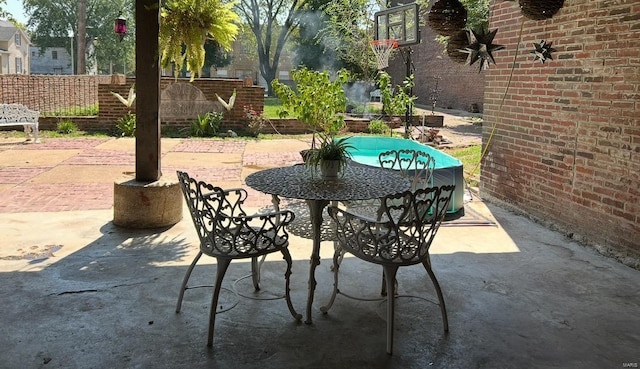 view of patio featuring fence