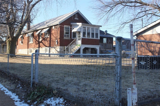 bungalow featuring fence private yard and brick siding