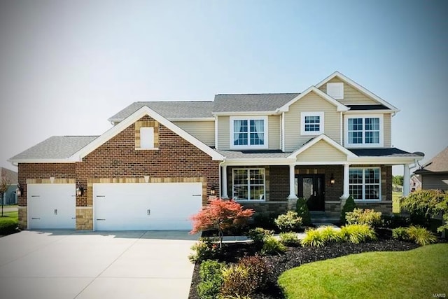 craftsman-style house featuring driveway, stone siding, an attached garage, and brick siding