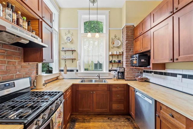 kitchen with butcher block counters, appliances with stainless steel finishes, under cabinet range hood, open shelves, and a sink