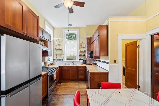 kitchen featuring a sink, stainless steel appliances, open shelves, and light countertops