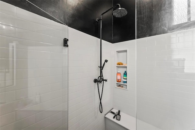 bathroom with tiled shower