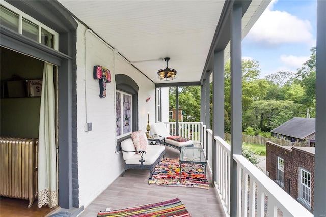 exterior space featuring covered porch and radiator heating unit