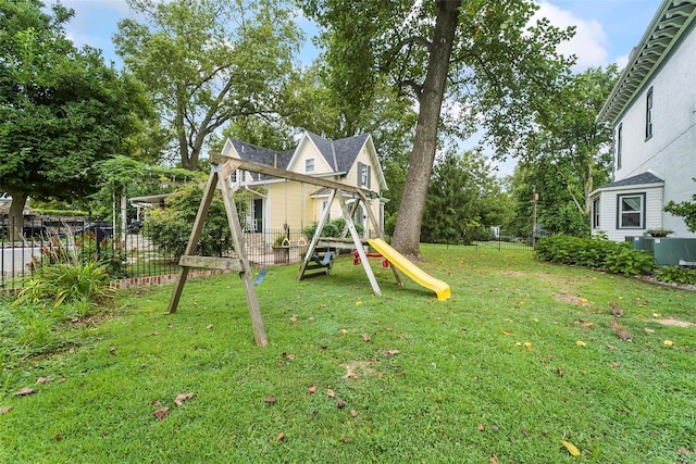 view of play area featuring a lawn and fence