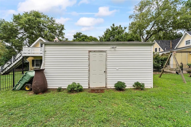 view of outbuilding with stairs and fence