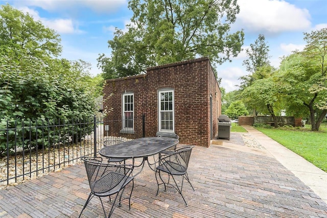 view of patio / terrace featuring fence, area for grilling, and outdoor dining space