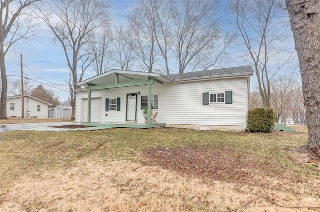 view of front of home featuring covered porch, concrete driveway, and a front yard