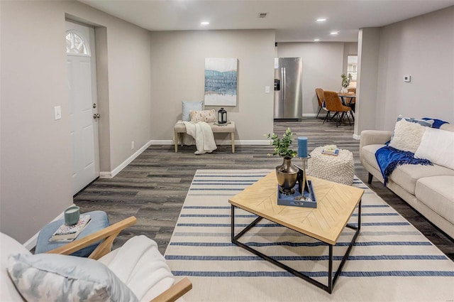 living room with baseboards, wood finished floors, and recessed lighting