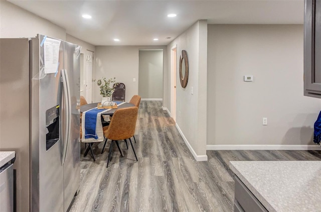 dining area with recessed lighting, baseboards, and wood finished floors