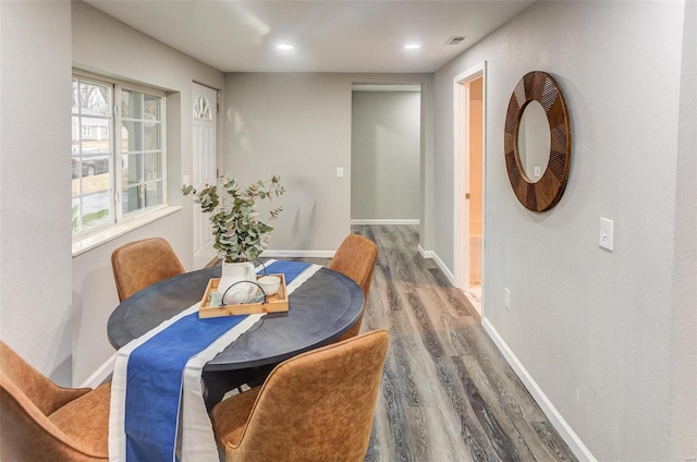 dining space with recessed lighting, visible vents, baseboards, and wood finished floors