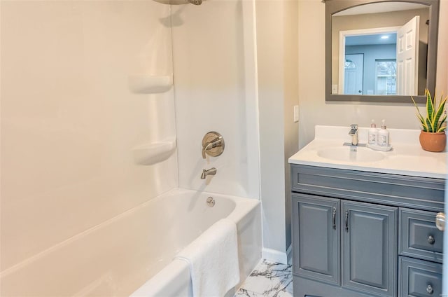 bathroom with  shower combination, marble finish floor, and vanity