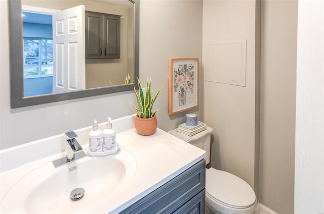 half bath featuring toilet and vanity