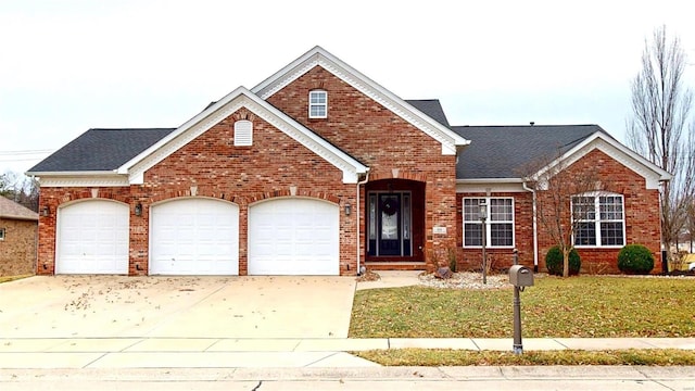 traditional-style home featuring a garage, concrete driveway, and brick siding