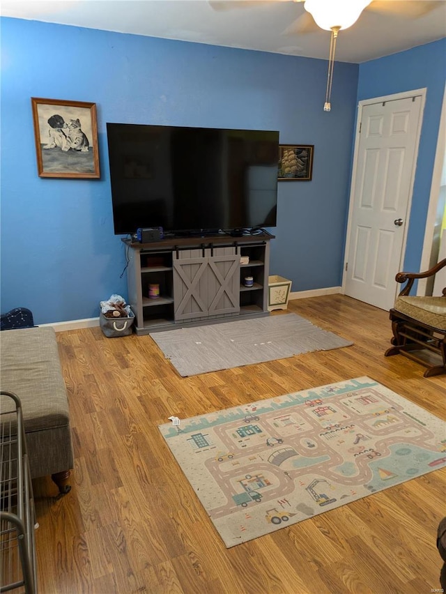 living room with baseboards and wood finished floors