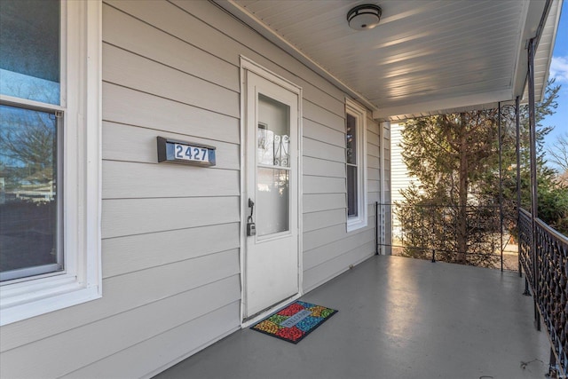 doorway to property featuring covered porch