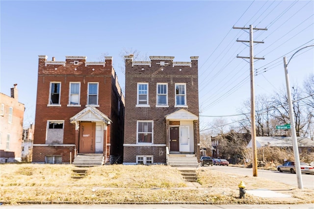 townhome / multi-family property with entry steps and brick siding