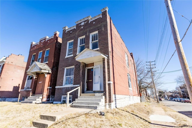 townhome / multi-family property with brick siding