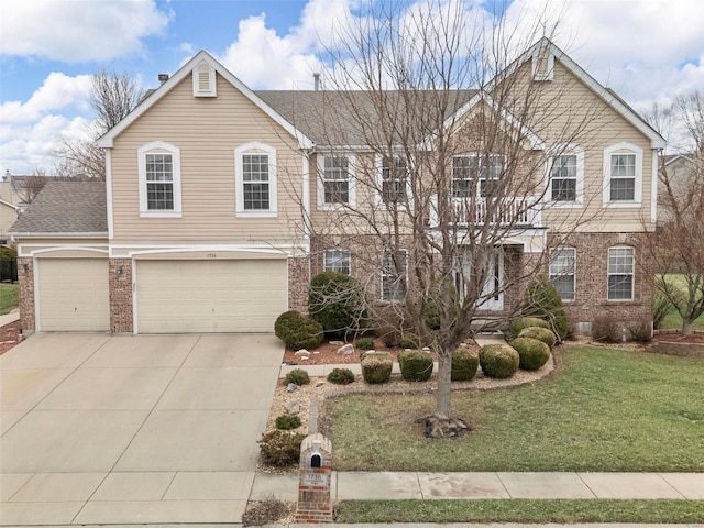 view of front of home with an attached garage, a front yard, concrete driveway, and brick siding