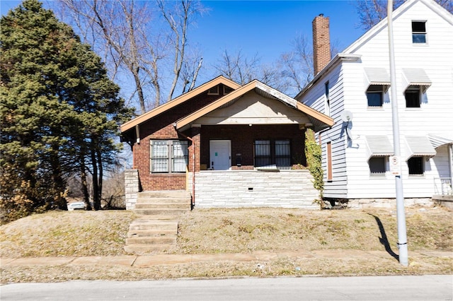 view of front of property with covered porch and brick siding