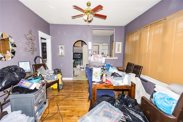 dining room with a ceiling fan, baseboards, and wood finished floors