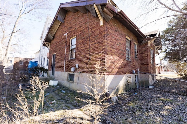 view of side of home with brick siding