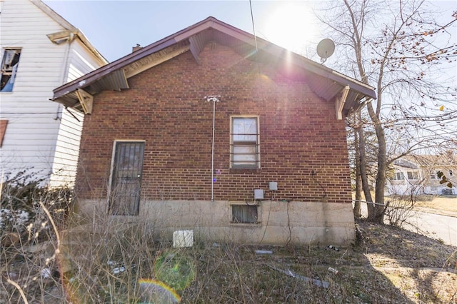 view of side of home with brick siding