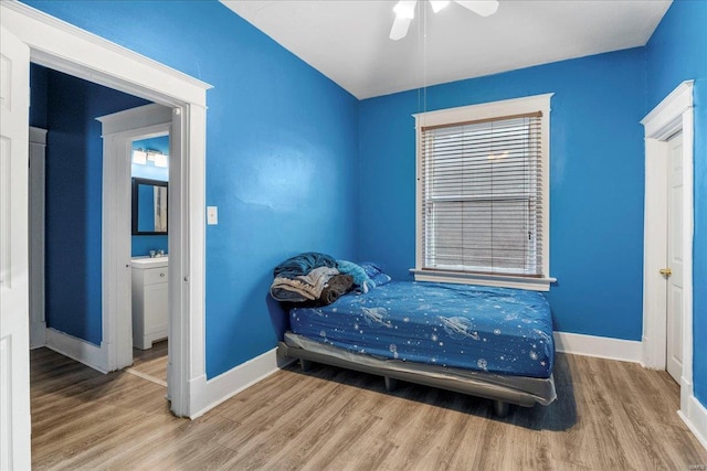 bedroom featuring baseboards and wood finished floors