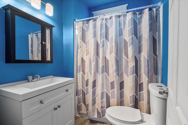 full bathroom with wood finished floors, vanity, toilet, and a shower with curtain