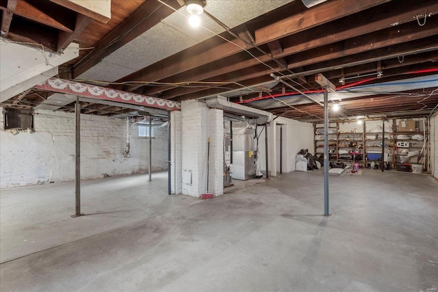 unfinished basement featuring heating unit