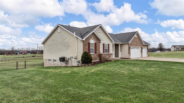 view of front facade with a garage, driveway, brick siding, and a front yard