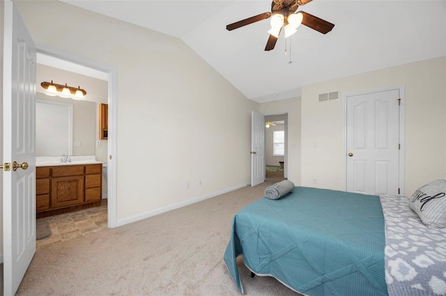 bedroom with lofted ceiling, light colored carpet, a sink, visible vents, and baseboards