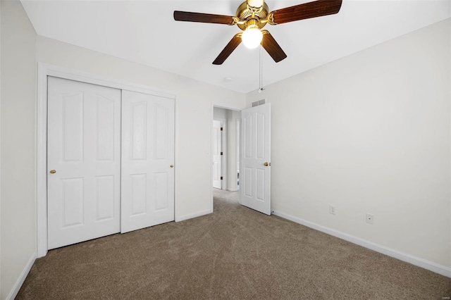 unfurnished bedroom featuring visible vents, baseboards, ceiling fan, carpet flooring, and a closet