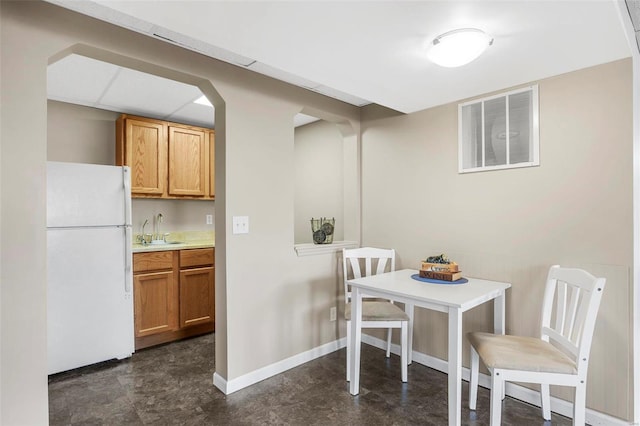 dining room featuring baseboards and visible vents